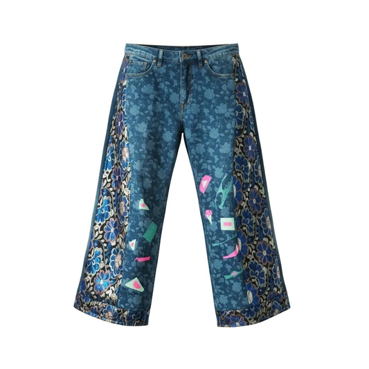 Handmade upcycled wide leg denim jeans with deep blue and gold floral jacquard panels running full length and scattered neon pink and mint hand-applied geometric appliqué details