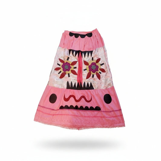 Pink tie-dye upcycled skirt with appliqué and embroidery front view
Detail of textured embroidery and patchwork on artistic skirt
Model wearing circus-inspired upcycled statement skirt
Close-up of pink, black, and brown fabric layers
One-of-a-kind handmade art skirt with mixed media design