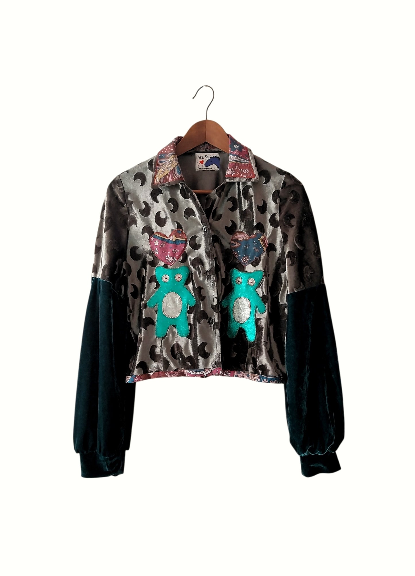 "Model wearing pewter moon-print cropped jacket with emerald velvet bishop sleeves and jade teddy bear appliqués — Midnight Bear Jacket"