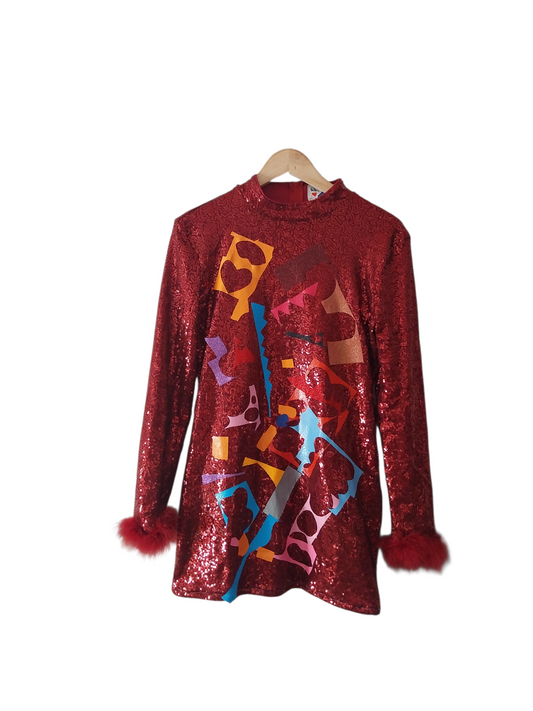 “Close-up of red sequin upcycled dress with abstract mosaic textile details and handmade patchwork”